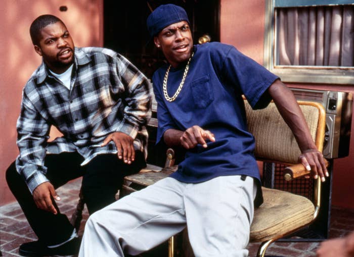 Ice Cube and Chris Tucker lean back while sitting down
