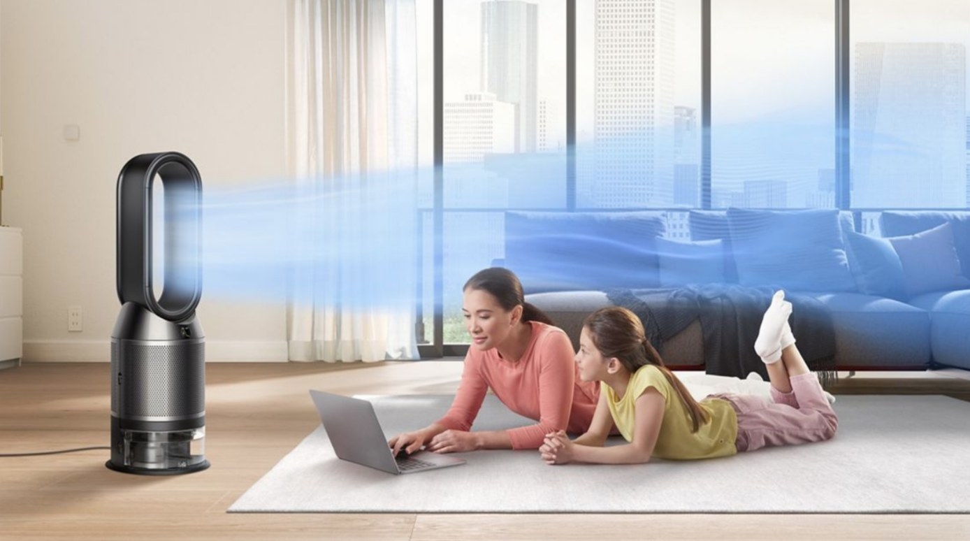 Two models lying down in front of a black/nickel purifier and humidifier cooling system