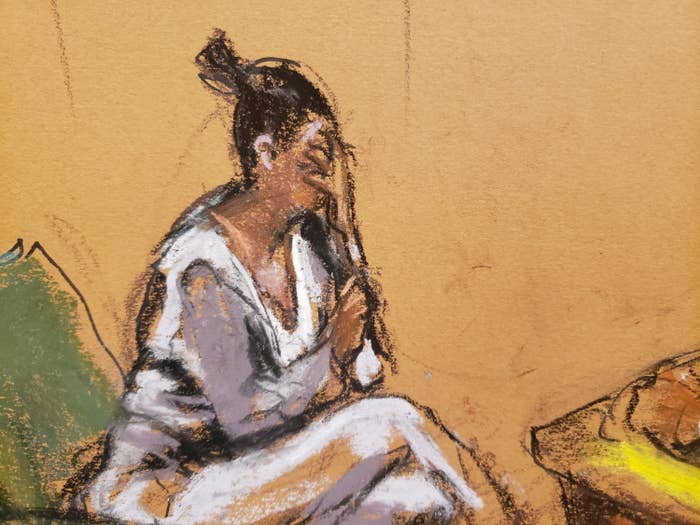 A courtroom sketch shows a Black woman holding a microphone with her hand on her face