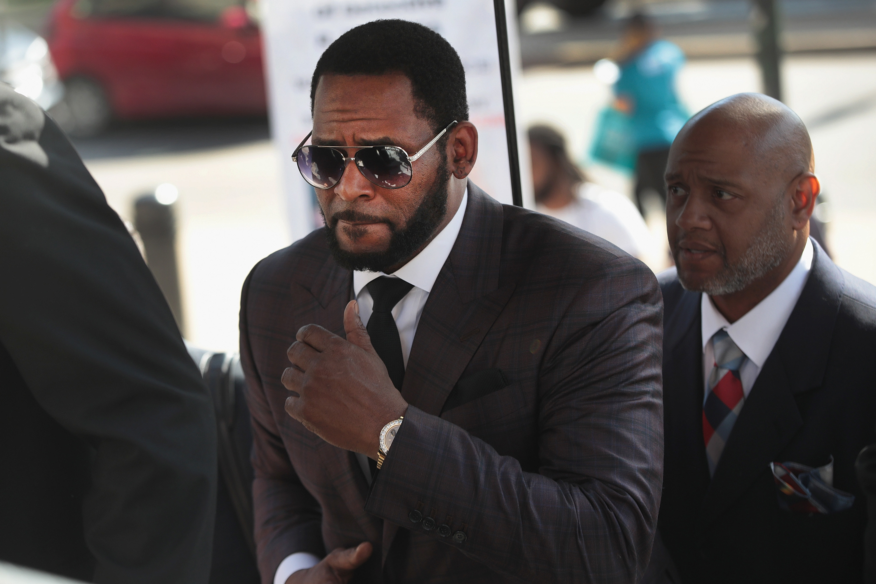 R. Kelly wears a suit while heading to a court appearance