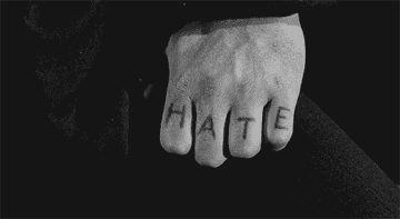 A fist with &quot;hate&quot; written on the knuckles clenching