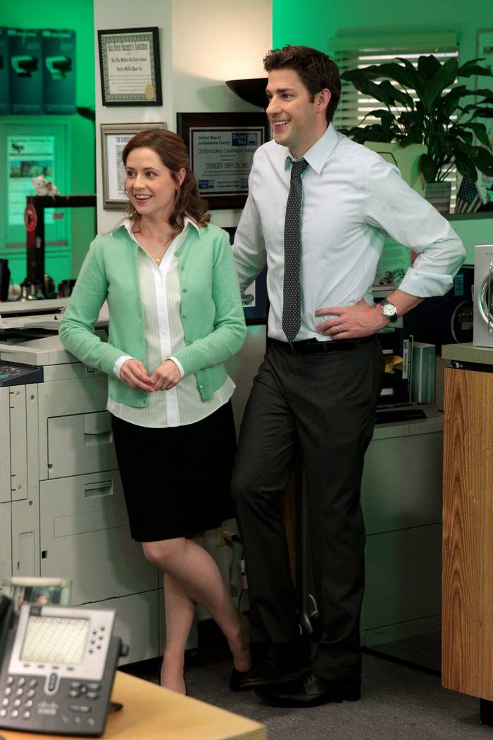 Pam and Jim stand next to each other at the copier
