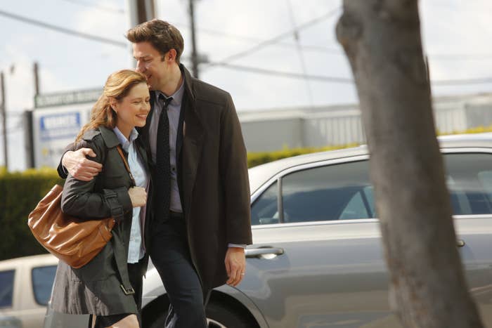 Jim kisses Pam on the head as they walk in the parking lot