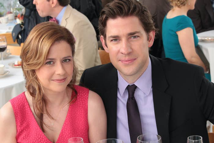 Jim and Pam sit next to each other at a reception in The Office