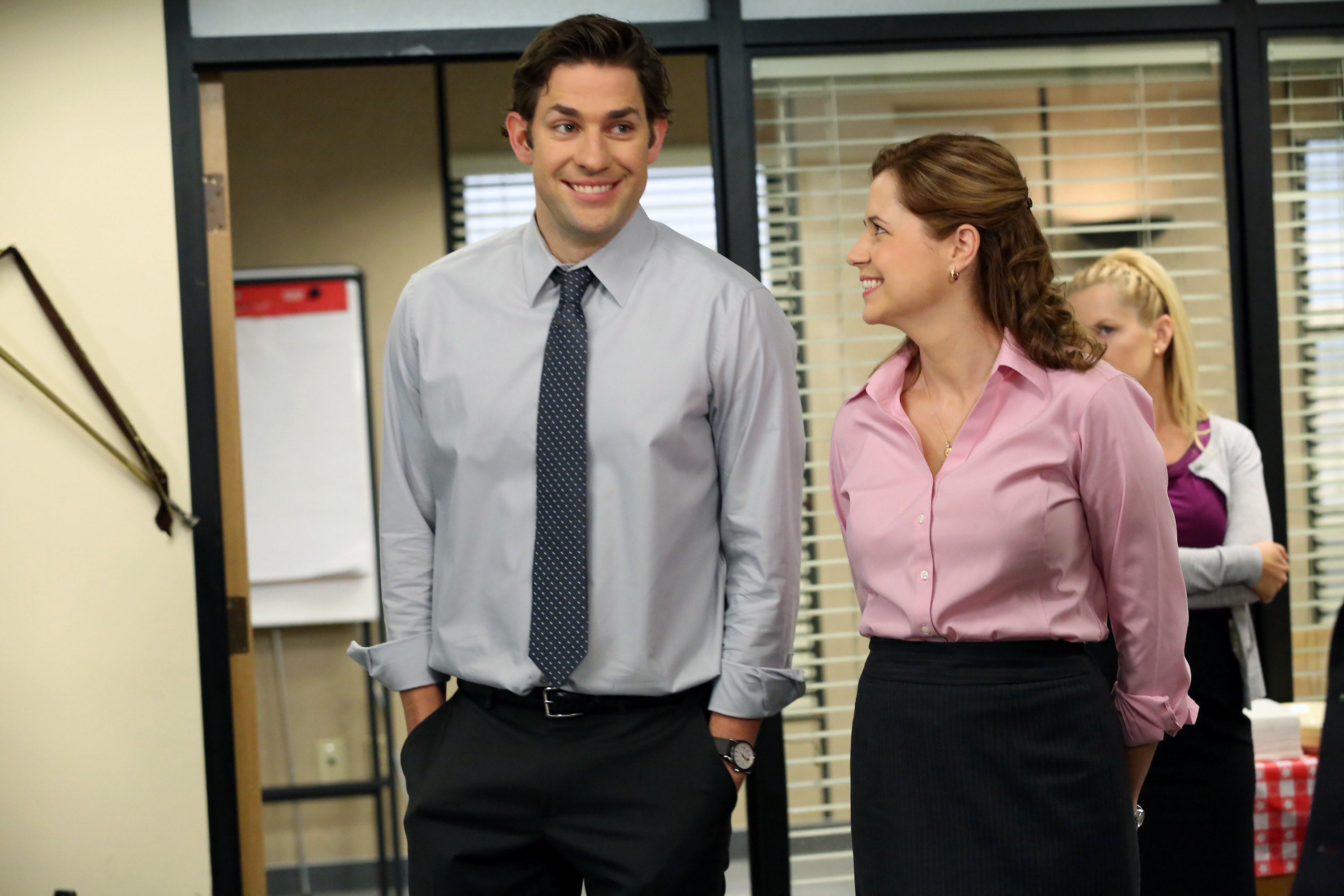 Jim stands next to Pam with his hands in his pockets