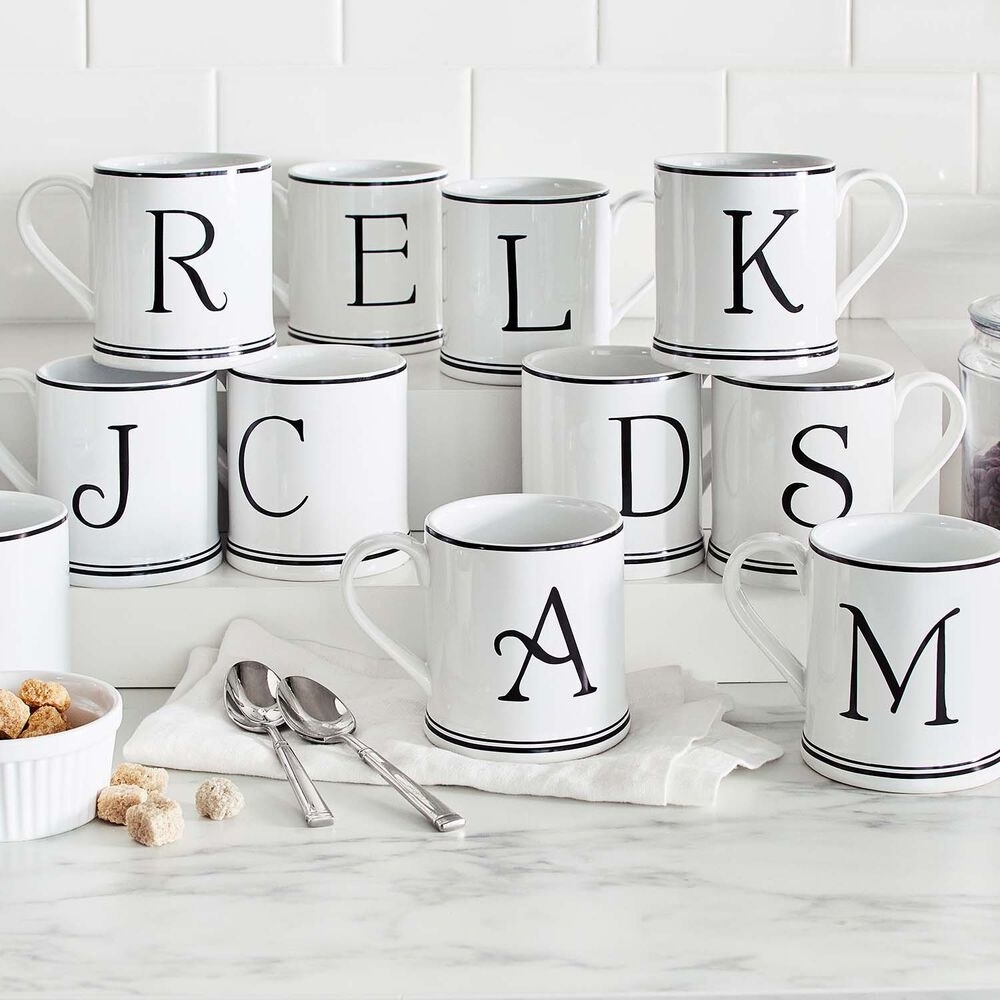 white cups with black letters in a stylized font