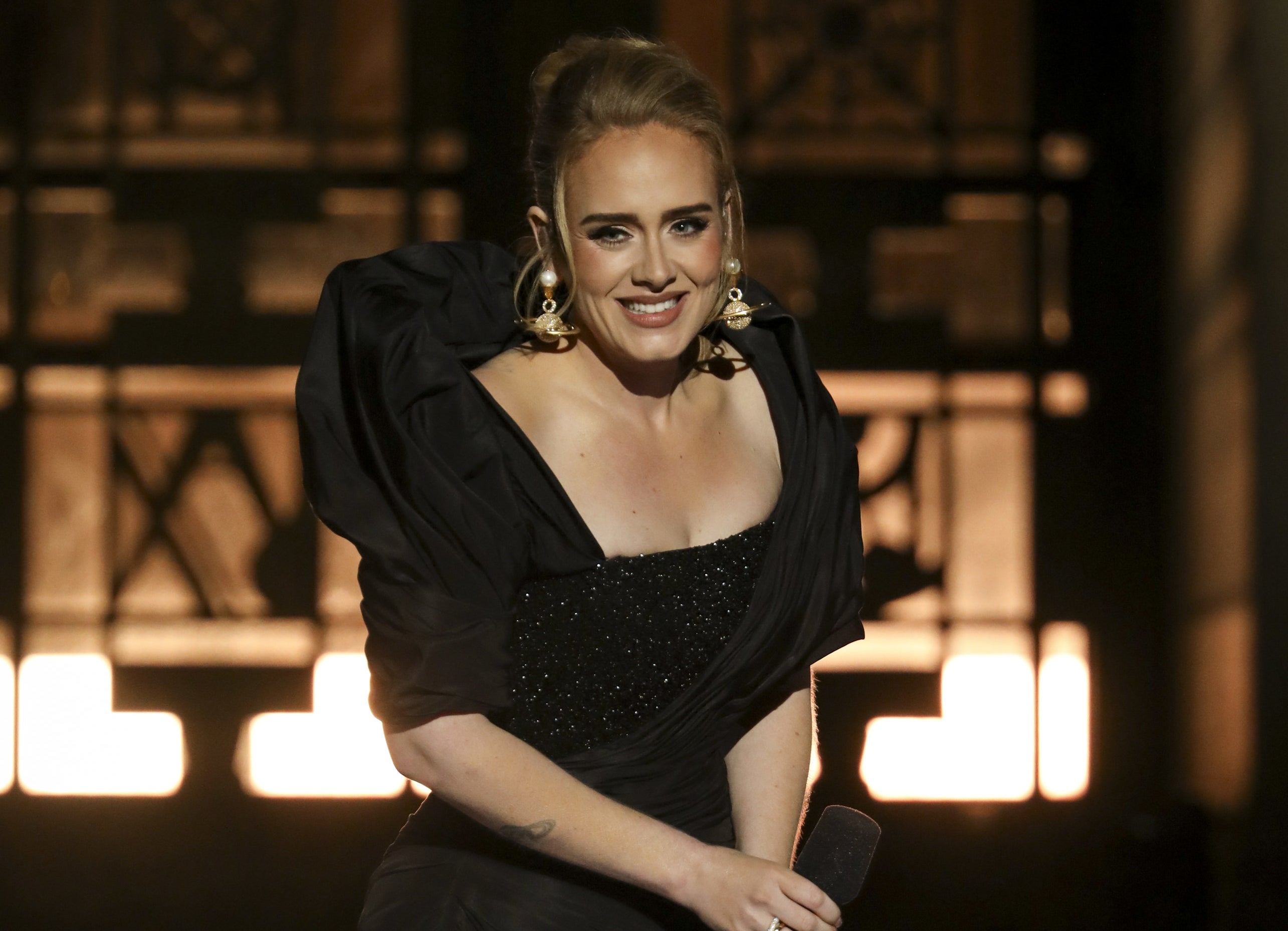 Adele smiles while on stage