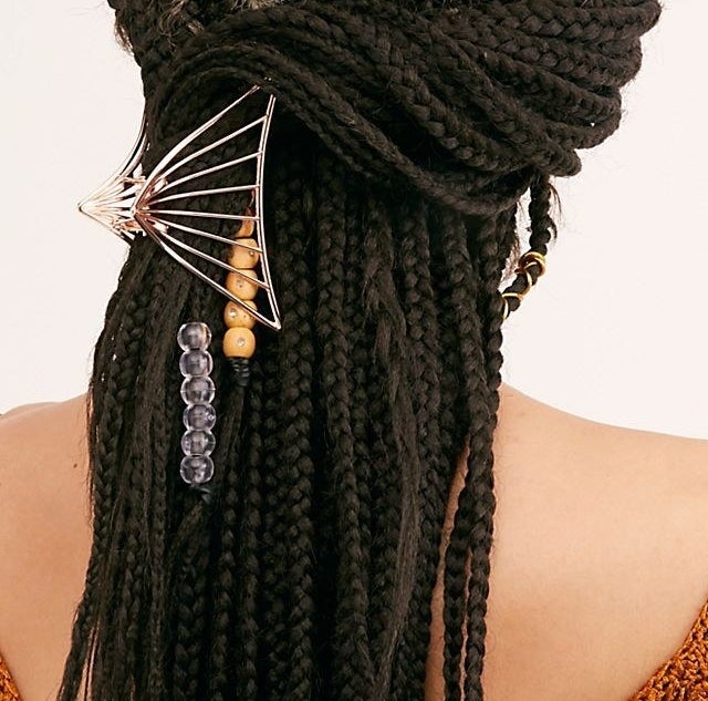 model with triangular metal claw clip in their hair