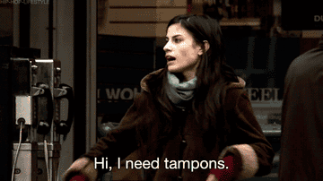 Lady in an advert asking for tampons in the street.