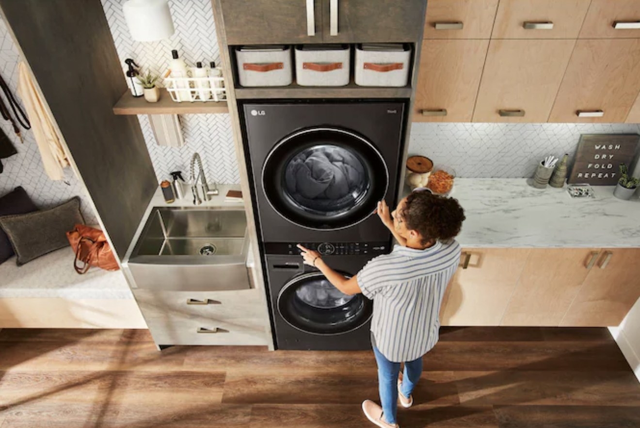 A woman adjusting the central settings on the dryer