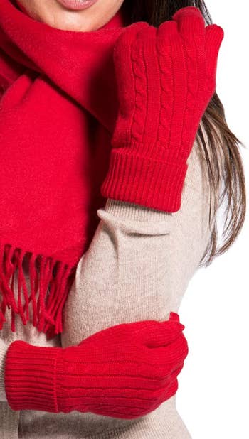 model in red cable knit gloves
