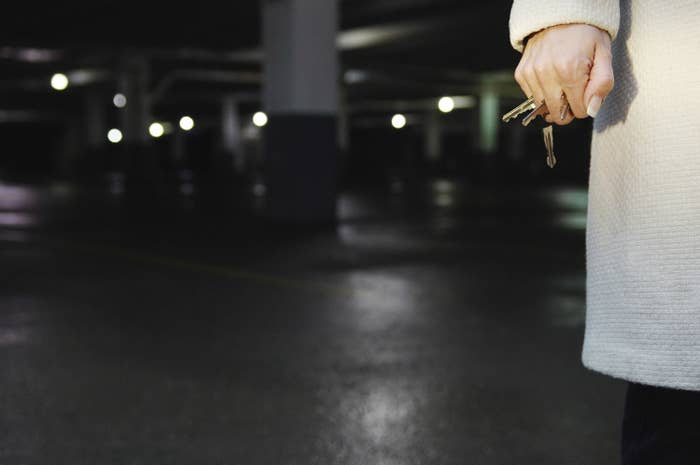 A woman holding her keys in a parking lot