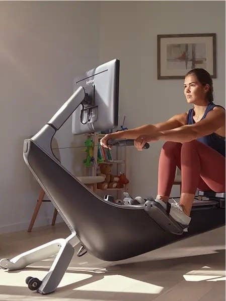 A person working out on a Hydrow rowing machine.