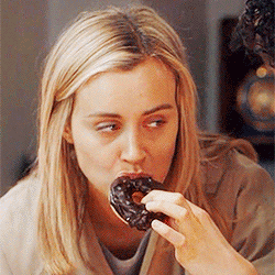 Woman slowly eats chocolate donut