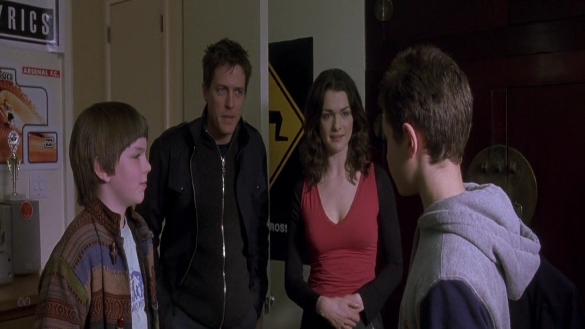 Hugh Grant and Rachel Weisz look at two boys looking at each other