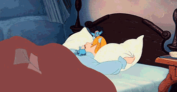 gif of cinderella grabbing her pillow and turning over in bed surrounded by little birds