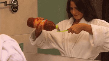Woman brushes her teeth with hot sauce