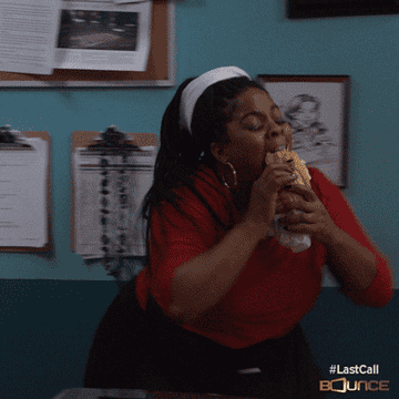 Woman happily eating a sandwich