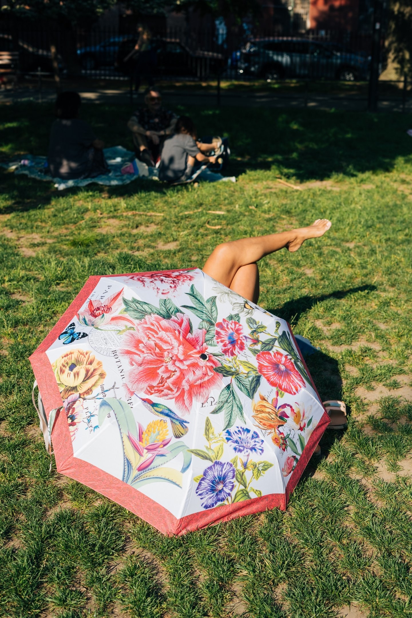 Jutharat Pinyodoonyachet, Umbrella (showing a woman&#x27;s bare crossed legs emerging from underneath a flower-decorated umbrella