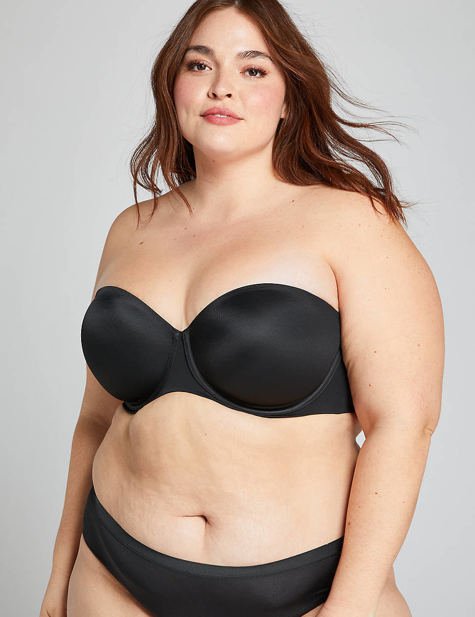Model wearing black strapless bra and panties