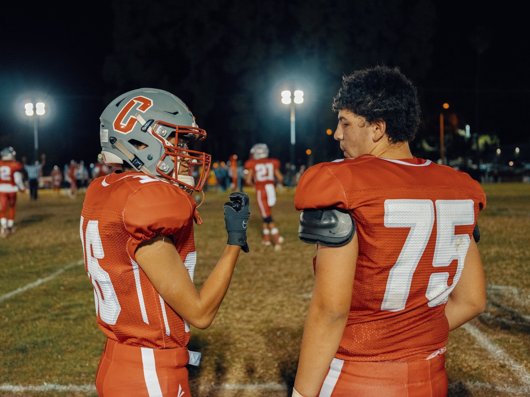 Wide receiver Joshua Cypert confers with defensive tackle Xavier Gamboa during a game