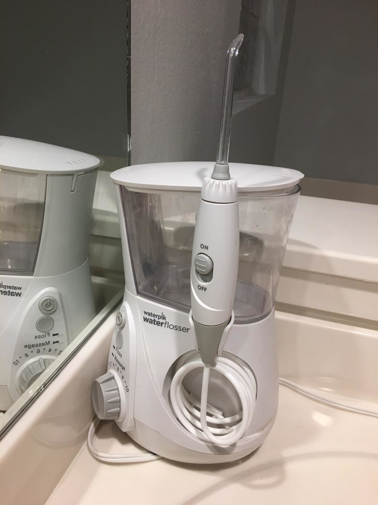 the flosser in white on a counter