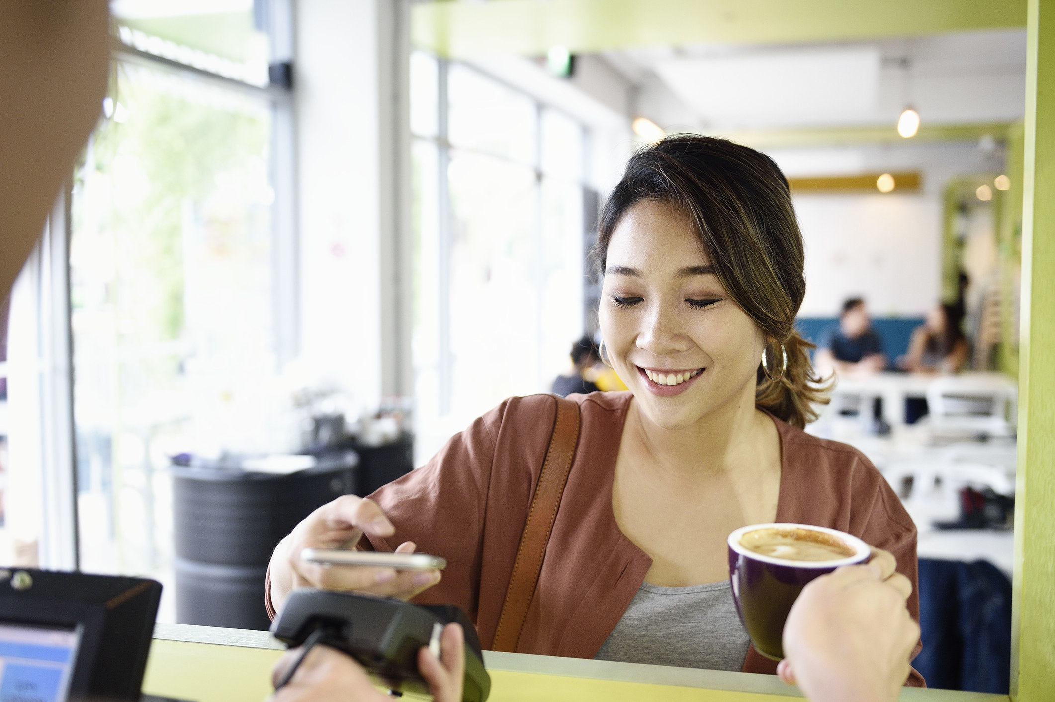 A woman paying for her coffee