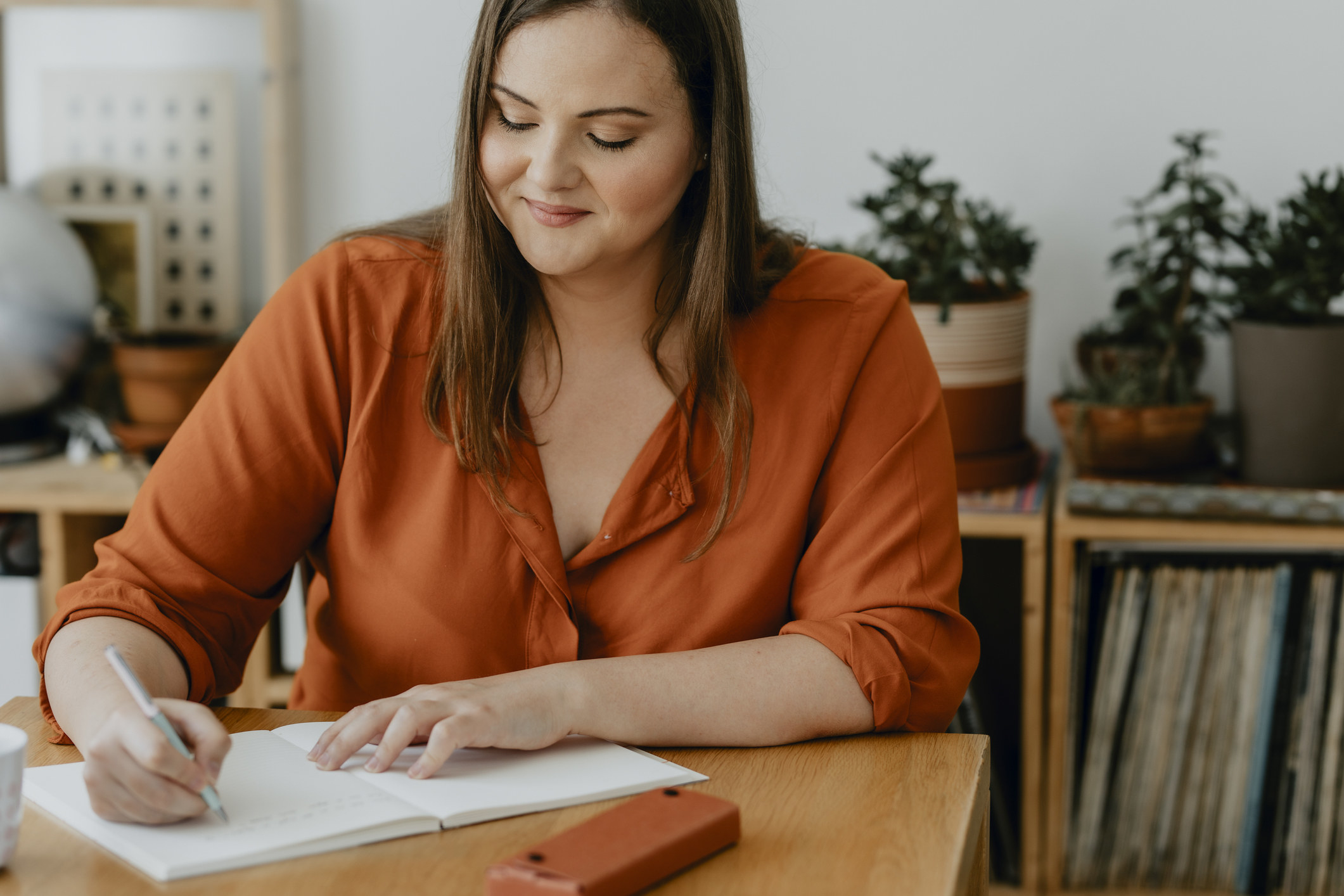 A woman writing on a notebook