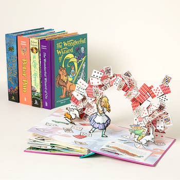 pop up book with alice being attacked by cards