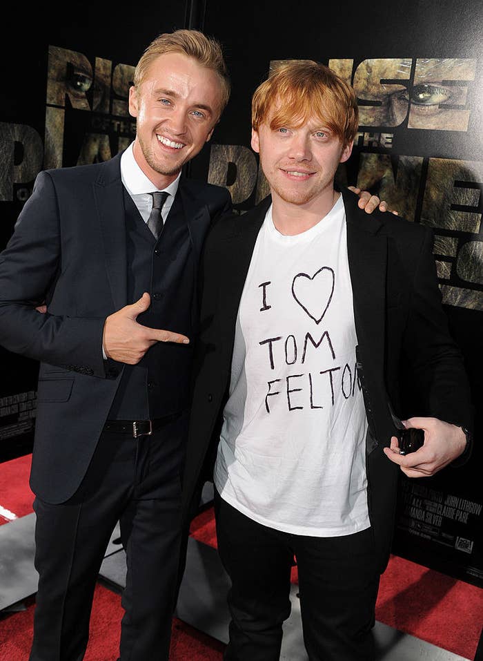 Rupert showing his shirt to Tom on the red carpet