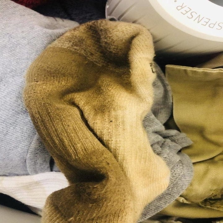 a dirty white sock with brown stains