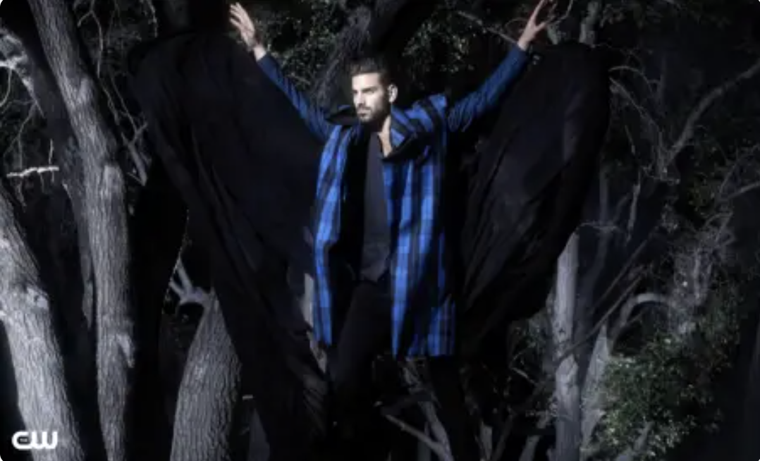 Nyle posing in a dark forest