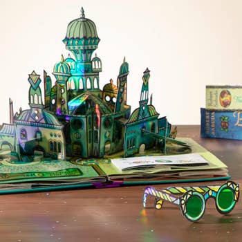 emerald city pop up page next to green paper glasses