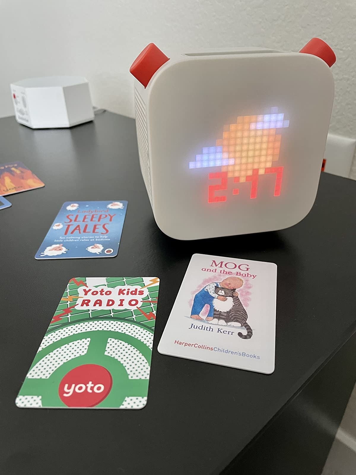 a reviewer&#x27;s yoto device with various yoto cards