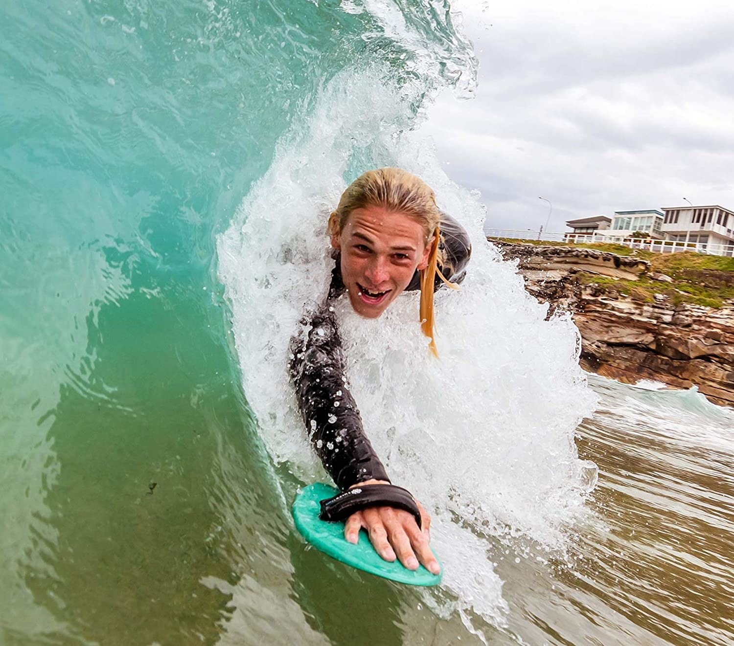 A person bodysurfing with the WAW Badfish handplane.