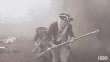 Revolutionary War soldiers running amid explosions on a battlefield