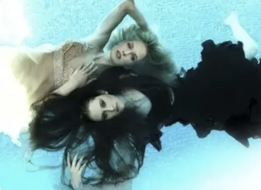 CariDee and Amanda floating in the pool