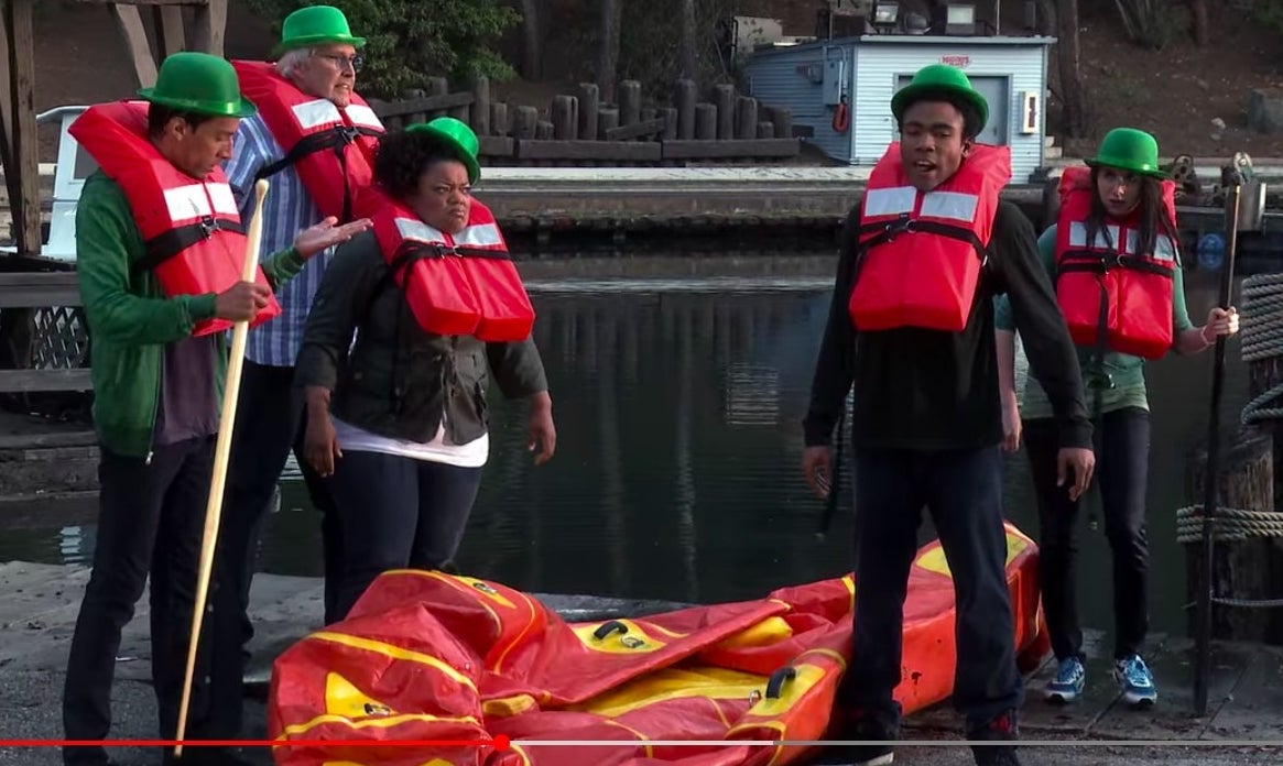 The study group, except Jeff and Britta, standing by a deflated raft in life vests, in &quot;Community&quot;