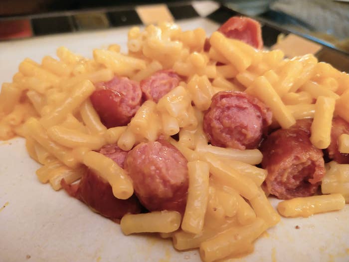 Mac &#x27;n&#x27; cheese with sliced hot dog.