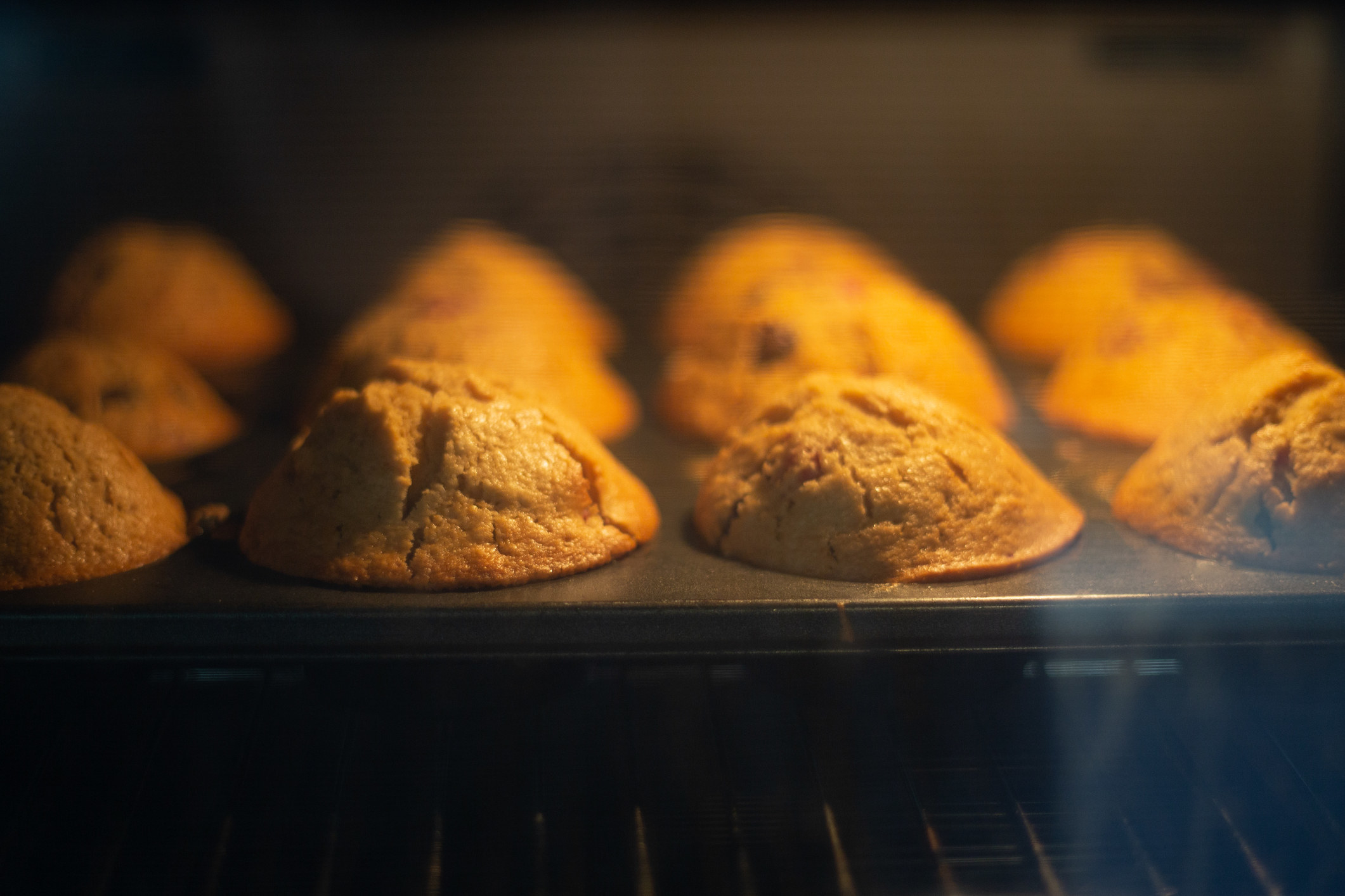 Muffins baking in a muffin tin.