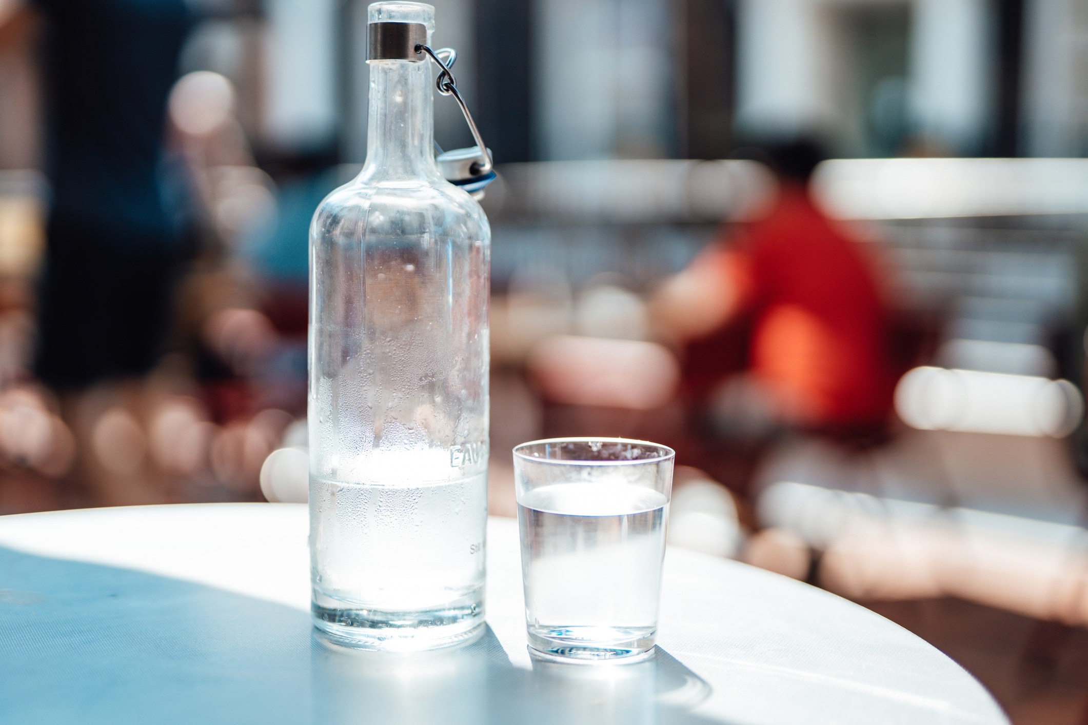 A carafe and a glass of water on a table.