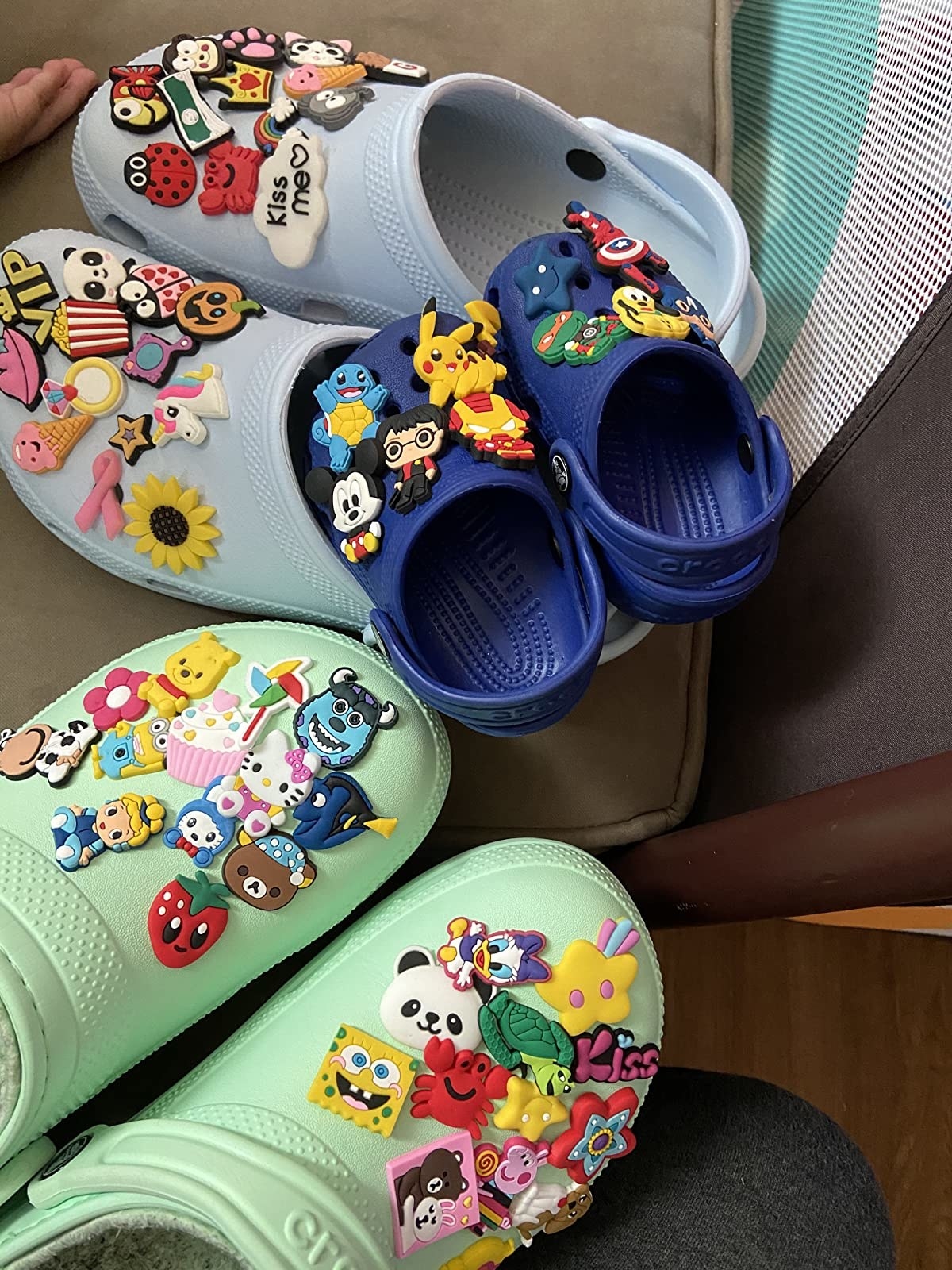 reviewer&#x27;s crocs with a bunch of different charms on them
