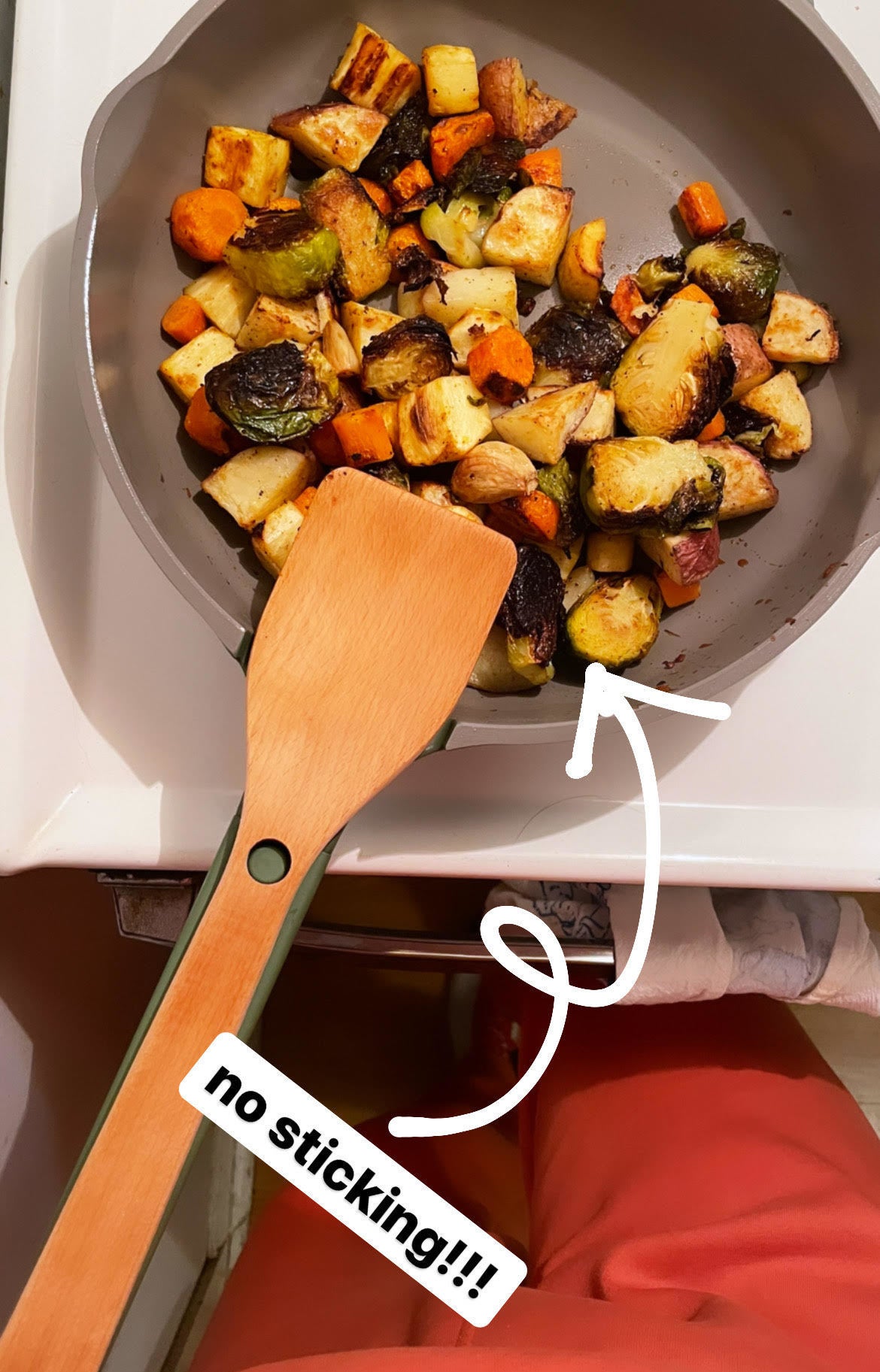 A bunch of veggies not sticking to the pan while it is sitting on a stove