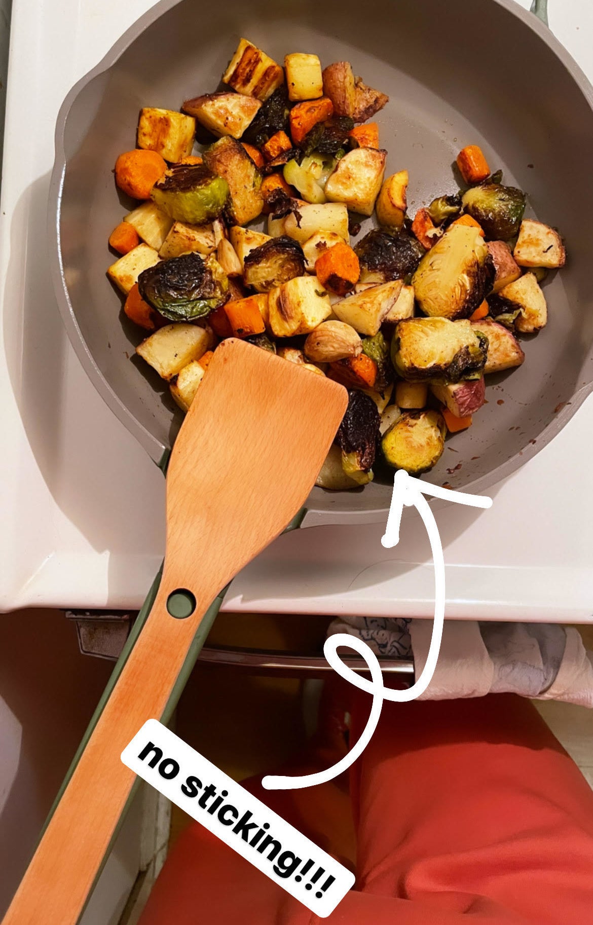 A bunch of veggies not sticking to the pan while it is sitting on a stove