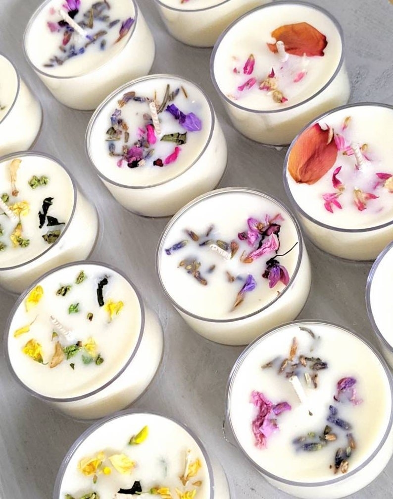 A variety of flower-adorned soy wax tea light candles