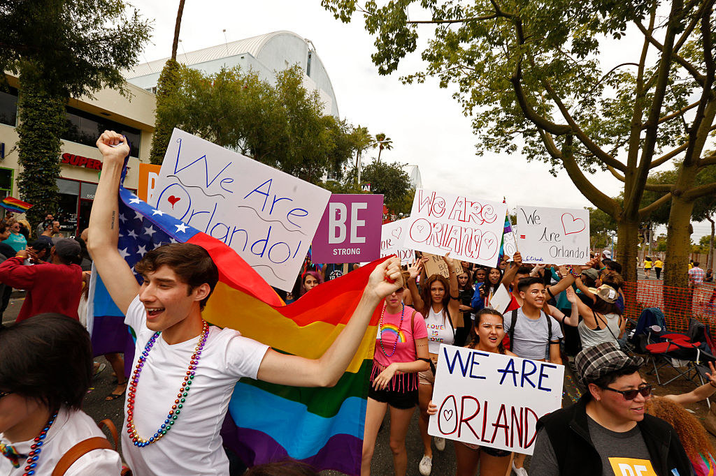 Marchers carry signs that read, &quot;We Are Orlando,&quot; while walking down Santa Monica Blvd. during the annual Gay Pride parade in West Hollywood on June 12, 2016