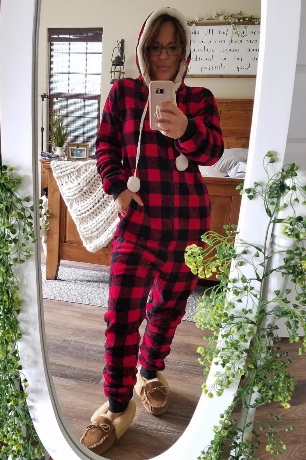 Reviewer wearing the red buffalo plaid onesie