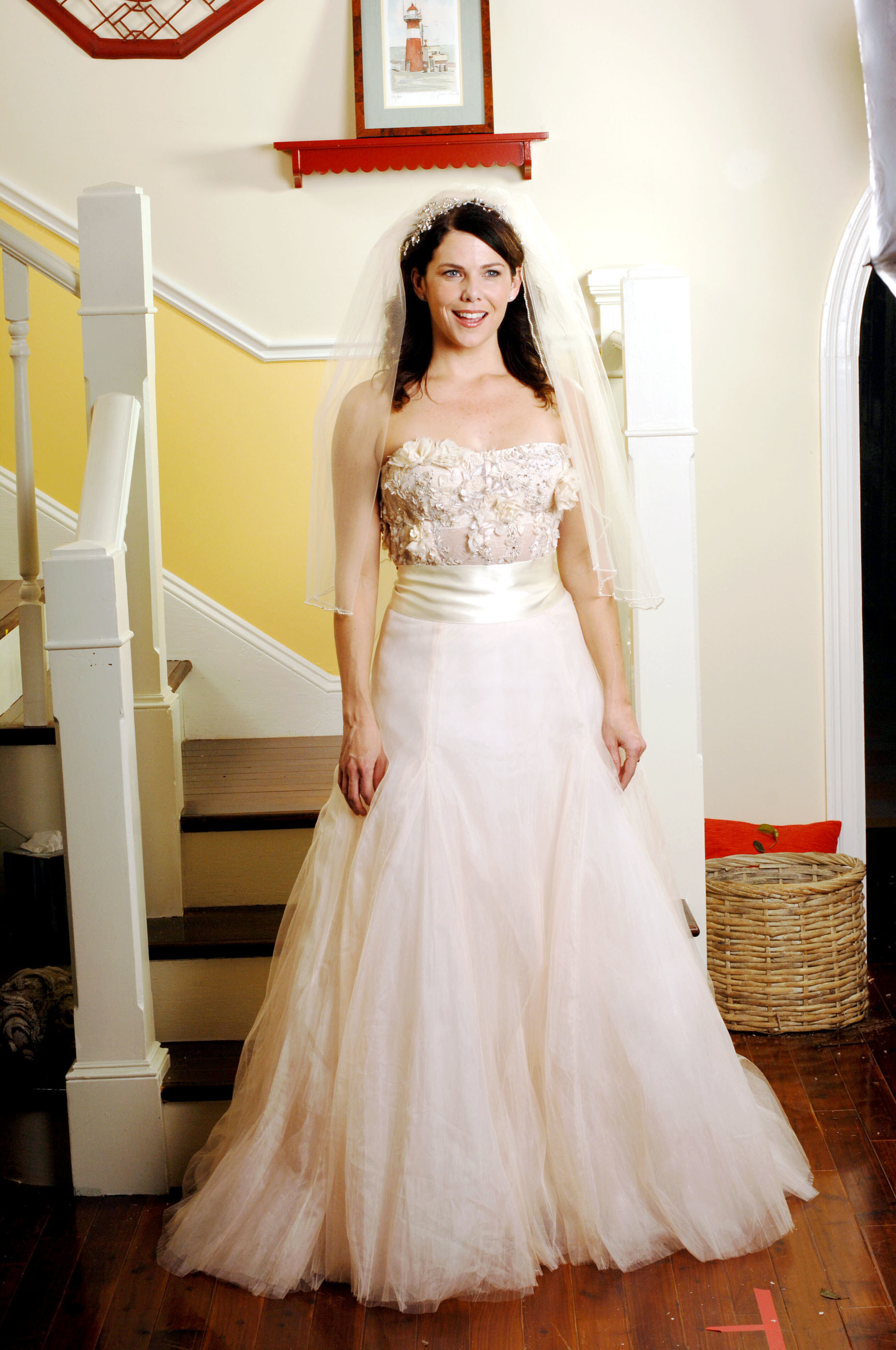 Lorelai wearing a strapless dress with an embroidered top and a somewhat big skirt