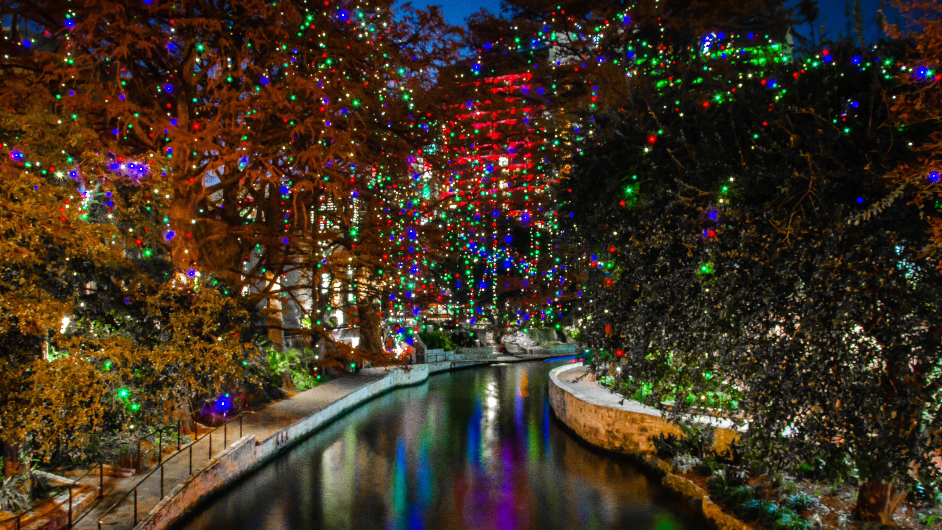 San Antonio River Walk with colorful Christmas lights decorating the trees