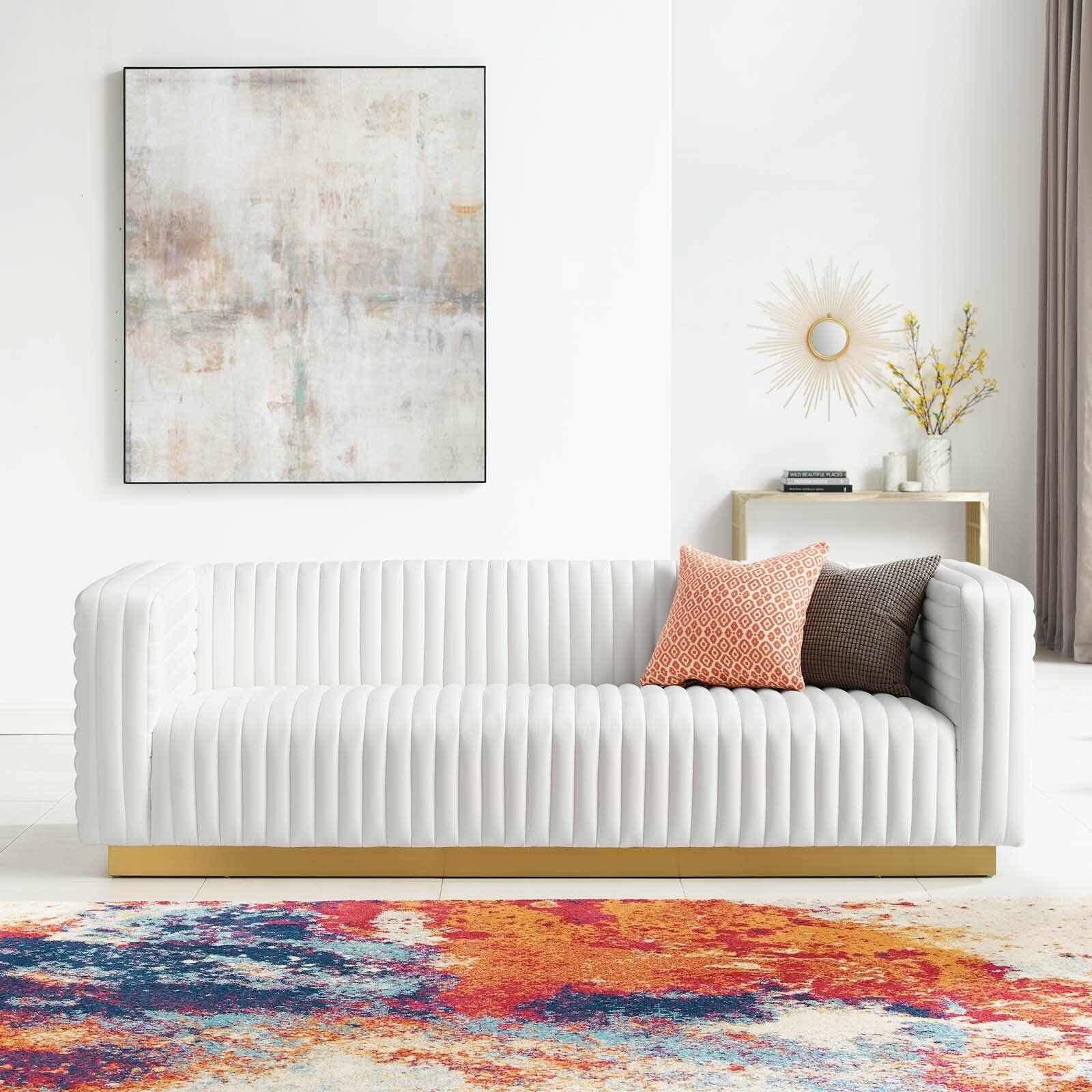 the white fluted velvet couch with gold detail